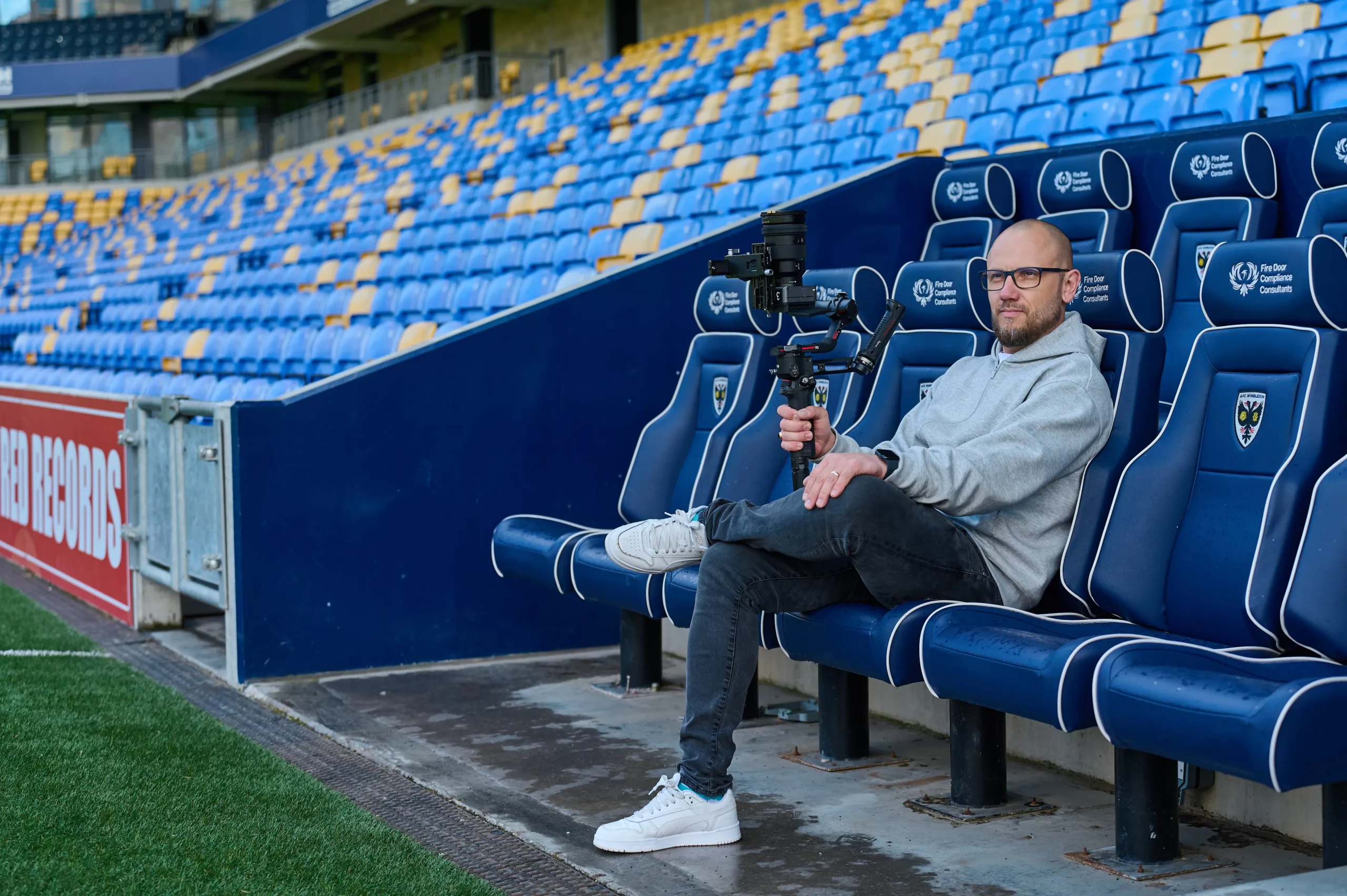 Banana Swift videographer with a camera gimbal at AFC Wimbledon stadium