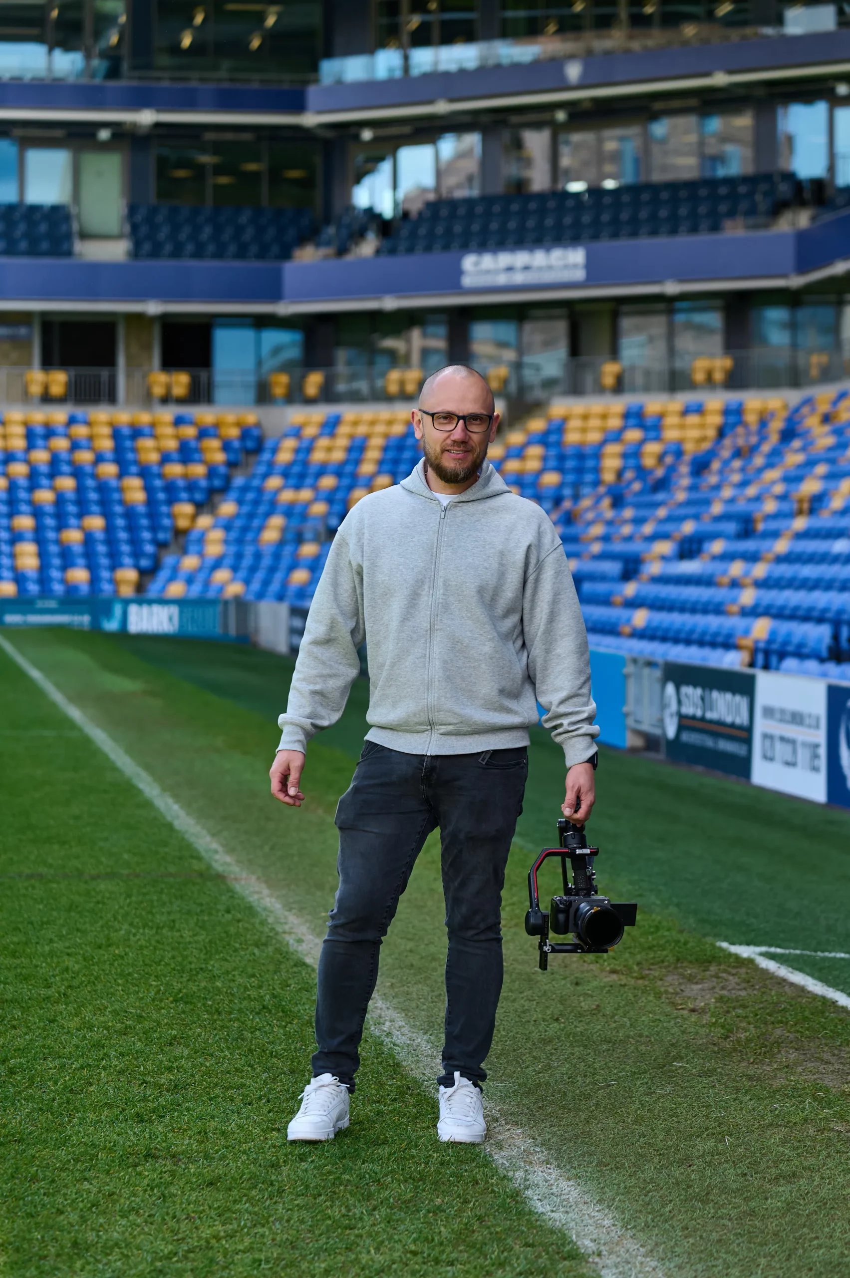 Event videographer beside the pitch at AFC Wimbledon stadium